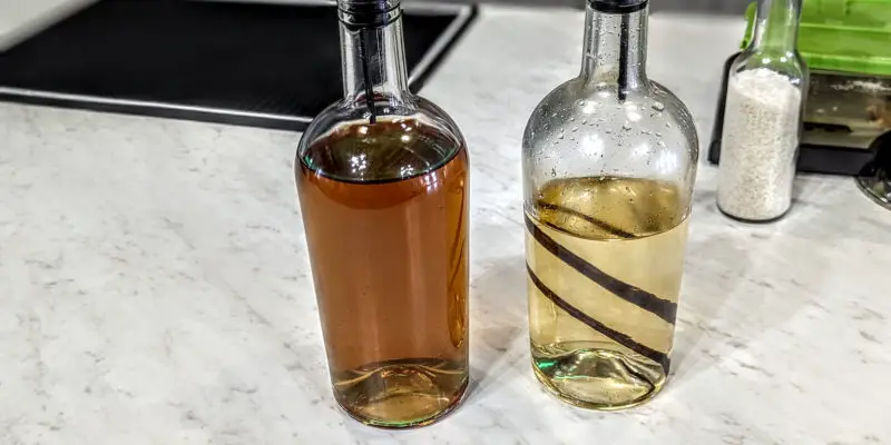 bottles of smoked simple syrup with mint and vanilla