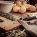 Man prepping ribs with grilling rub in kitchen